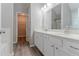 Bathroom featuring double sinks, white cabinets, and modern fixtures at 223 Gilliam Ct, Locust Grove, GA 30248