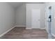 Bedroom with a door leading into another room and laminate flooring at 223 Gilliam Ct, Locust Grove, GA 30248