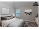 Stylishly staged bedroom with hardwood floors, bright window, neutral paint and lovely artwork at 223 Gilliam Ct, Locust Grove, GA 30248