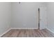 Bright bedroom featuring neutral walls and light wood-look flooring at 223 Gilliam Ct, Locust Grove, GA 30248