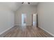 Vaulted ceiling bedroom showcasing gray flooring, leading to closet and ensuite at 223 Gilliam Ct, Locust Grove, GA 30248