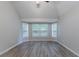 Bedroom featuring hardwood floors, a vaulted ceiling, and large bright windows at 223 Gilliam Ct, Locust Grove, GA 30248