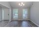 Bright dining room with modern gray flooring, chandelier, and natural light at 223 Gilliam Ct, Locust Grove, GA 30248