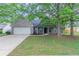 Charming single-story brick home with well-maintained lawn and attached garage at 223 Gilliam Ct, Locust Grove, GA 30248