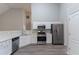Bright kitchen with stainless steel appliances, white cabinets, and modern flooring at 223 Gilliam Ct, Locust Grove, GA 30248