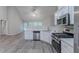 Kitchen featuring stainless steel appliances, modern white cabinetry, and open floor plan at 223 Gilliam Ct, Locust Grove, GA 30248