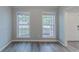 An empty living room showing the windows and door at 223 Gilliam Ct, Locust Grove, GA 30248
