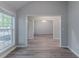 Open-concept living room and dining space with wood-look flooring at 223 Gilliam Ct, Locust Grove, GA 30248