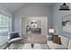 Living room featuring access to the dining room, stylish seating, and bright lighting at 223 Gilliam Ct, Locust Grove, GA 30248
