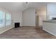 An empty living room featuring a fireplace, ceiling fan, and open access to the kitchen at 223 Gilliam Ct, Locust Grove, GA 30248