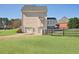 Large backyard with a well-maintained lawn, a two-car garage, and a wooden fence at 2810 Burgundy Dr, Cumming, GA 30041