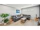 Finished basement with grey walls and flooring, featuring a sofa and natural lighting at 2810 Burgundy Dr, Cumming, GA 30041