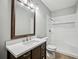 Bathroom featuring a wide mirror, a vanity, a shower and bathtub combo with white tiling at 2810 Burgundy Dr, Cumming, GA 30041