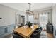 Elegant dining room with wainscoting, modern lighting, and a large wood table perfect for entertaining at 2810 Burgundy Dr, Cumming, GA 30041