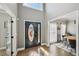 Welcoming foyer with hardwood floors, high ceilings, and a decorative front door at 2810 Burgundy Dr, Cumming, GA 30041