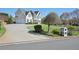 Beautiful home with a well-manicured lawn, mature trees, and a long driveway leading to a two-car garage at 2810 Burgundy Dr, Cumming, GA 30041