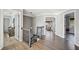 Hallway with hardwood floors, decorative railing, modern lighting, and access to multiple rooms at 2810 Burgundy Dr, Cumming, GA 30041