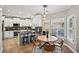 Cozy kitchen with white cabinetry, granite countertops, stainless steel appliances, and adjacent breakfast nook at 2810 Burgundy Dr, Cumming, GA 30041