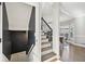 Carpeted staircase with black handrail and view of kitchen at 2810 Burgundy Dr, Cumming, GA 30041