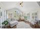 Bright sunroom boasts lots of natural light, vaulted ceiling, and comfortable seating at 2810 Burgundy Dr, Cumming, GA 30041