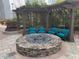 Community stone fire pit with seating area and trellised structure at 3324 Peachtree Ne Rd # 1116, Atlanta, GA 30326