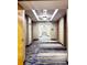 Long building hallway with patterned carpet and modern lighting at 3324 Peachtree Ne Rd # 1116, Atlanta, GA 30326