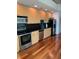 Modern kitchen with stainless steel appliances and hardwood floors at 3324 Peachtree Ne Rd # 1116, Atlanta, GA 30326
