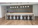 Bright kitchen area features bar seating with eight brown leather stools and modern pendant lighting at 3324 Peachtree Ne Rd # 1116, Atlanta, GA 30326