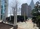 Outdoor seating area with tables and chairs, set among trees with downtown views at 3324 Peachtree Ne Rd # 1116, Atlanta, GA 30326
