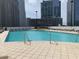 Rooftop pool area with lounge chairs, surrounded by city buildings at 3324 Peachtree Ne Rd # 1116, Atlanta, GA 30326