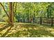 Secluded backyard area with a charming patio set under mature trees and near a dark wooden fence at 5440 Shady Grove Rd, Cumming, GA 30041