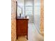 Floral wallpaper bathroom with an arched window and a dark wood vanity at 5440 Shady Grove Rd, Cumming, GA 30041