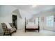 Bedroom with windows, chair, 4-post bed, white walls, and neutral carpet at 5440 Shady Grove Rd, Cumming, GA 30041