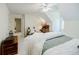 Cozy bedroom featuring a ceiling fan, white walls, neutral carpet, and an attached desk area at 5440 Shady Grove Rd, Cumming, GA 30041
