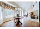 Bright dining area with hardwood floors, large windows, and views into the living room at 5440 Shady Grove Rd, Cumming, GA 30041