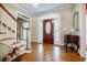 Elegant foyer with hardwood floors, decorative front door with sidelights, and staircase at 5440 Shady Grove Rd, Cumming, GA 30041