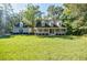 Charming single Gathering home with a covered front porch and a large manicured front lawn at 5440 Shady Grove Rd, Cumming, GA 30041