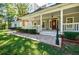 Beautiful front exterior of the home featuring a large covered porch and attractive landscaping at 5440 Shady Grove Rd, Cumming, GA 30041