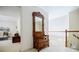 Hallway with a decorative mirror with hooks, a view into bedroom, and the stairs at 5440 Shady Grove Rd, Cumming, GA 30041