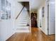 Bright hallway with hardwood floors, a staircase, and storage, connecting different areas of the home at 5440 Shady Grove Rd, Cumming, GA 30041