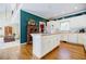 Spacious kitchen with white cabinetry, a central island, and hardwood floors at 5440 Shady Grove Rd, Cumming, GA 30041