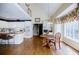 Open-concept kitchen and dining area with hardwood floors and vaulted ceilings at 5440 Shady Grove Rd, Cumming, GA 30041