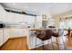 Charming kitchen with white cabinetry, a central island, and hardwood floors at 5440 Shady Grove Rd, Cumming, GA 30041