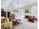 Open-concept living room with fireplace, large windows, and adjacent dining area with hardwood flooring at 5440 Shady Grove Rd, Cumming, GA 30041