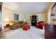 Comfortable living room with couch, chair, end tables, and an open bookcase at 5440 Shady Grove Rd, Cumming, GA 30041