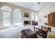 Bright living room featuring large windows, a fireplace, and access to an outdoor deck at 5440 Shady Grove Rd, Cumming, GA 30041
