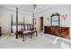 Spacious main bedroom with a four-post bed, decorative furniture, and neutral tones at 5440 Shady Grove Rd, Cumming, GA 30041