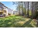 Large, private backyard surrounded by mature trees with a playhouse at 6065 Nw Gentlewind Court Nw Ct, Powder Springs, GA 30127