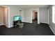 Open basement area featuring access to other rooms and a television at 6065 Nw Gentlewind Court Nw Ct, Powder Springs, GA 30127