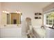 Bright bathroom with double sinks, soaking tub, and walk-in shower, offering a spa-like experience at 6065 Nw Gentlewind Court Nw Ct, Powder Springs, GA 30127
